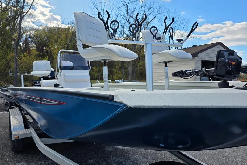 Slide: The Image of 2022 Ranger RB200 boat with fishing seats and rod holders, parked outdoors. - 6