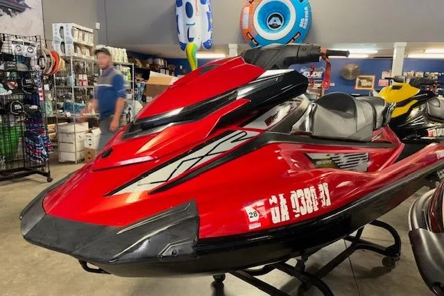 Slide: The Image of Red 2015 Yamaha WaveRunner VXR jet ski displayed in a showroom. - 3