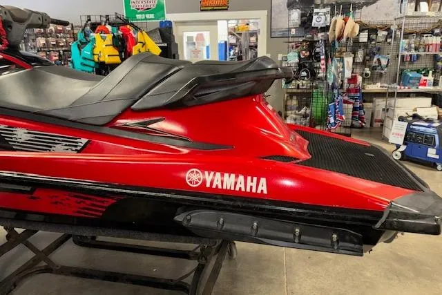 Slide: The Image of Red 2015 Yamaha WaveRunner VXR jet ski in a showroom with accessories. - 5