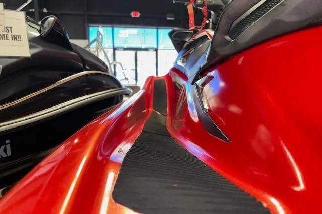 Slide: The Image of 2015 Yamaha WaveRunner VXR in showroom, vibrant red color, sleek design. - 9