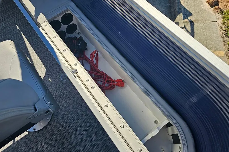 Slide: The Image of Storage compartment in 2021 Bennington SX 22 Fishing boat with red extension cord. - 14