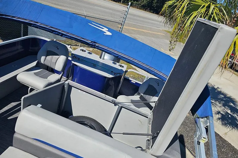 Slide: The Image of 2021 Bennington SX 22 Fishing boat interior with seating and blue canopy. - 16