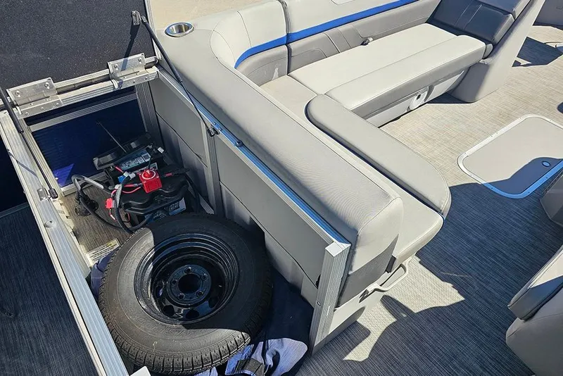 Slide: The Image of 2021 Bennington SX 22 Fishing boat interior with storage compartment and spare tire. - 17