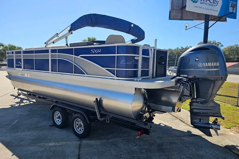 Slide: The Image of 2021 Bennington SX 22 Fishing pontoon boat with Yamaha outboard motor on trailer. - 3