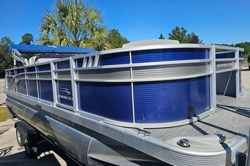 Slide: The Image of 2021 Bennington SX 22 Fishing pontoon boat with blue panels and silver railing. - 5
