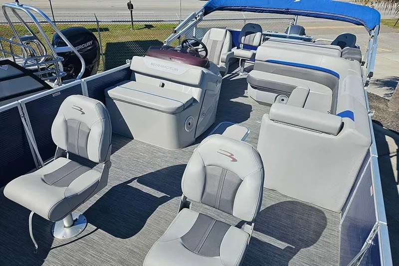Slide: The Image of 2021 Bennington SX 22 Fishing boat interior with gray seating and blue canopy. - 8