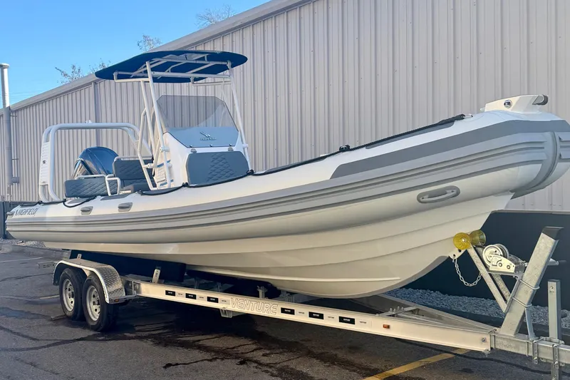 The Image of 2025 Highfield Patrol 760 boat on trailer, parked beside a building. - 0