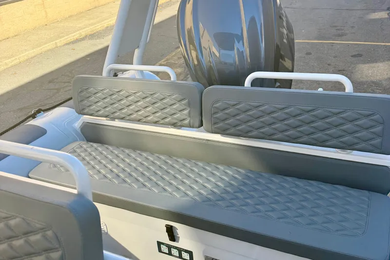 Slide: The Image of 2025 Highfield Patrol 760 boat with diamond-stitched gray seating and modern interior design. - 13