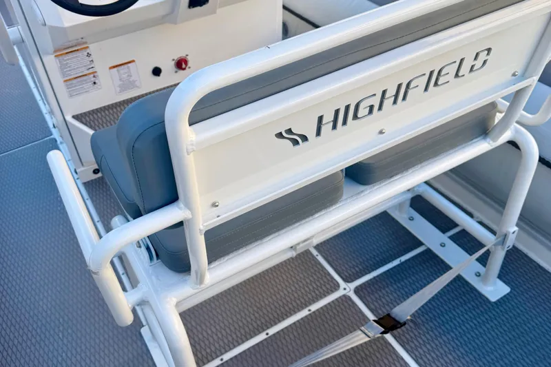 Slide: The Image of 2025 Highfield Patrol 760 boat dashboard with Simrad navigation system and steering wheel. - 15