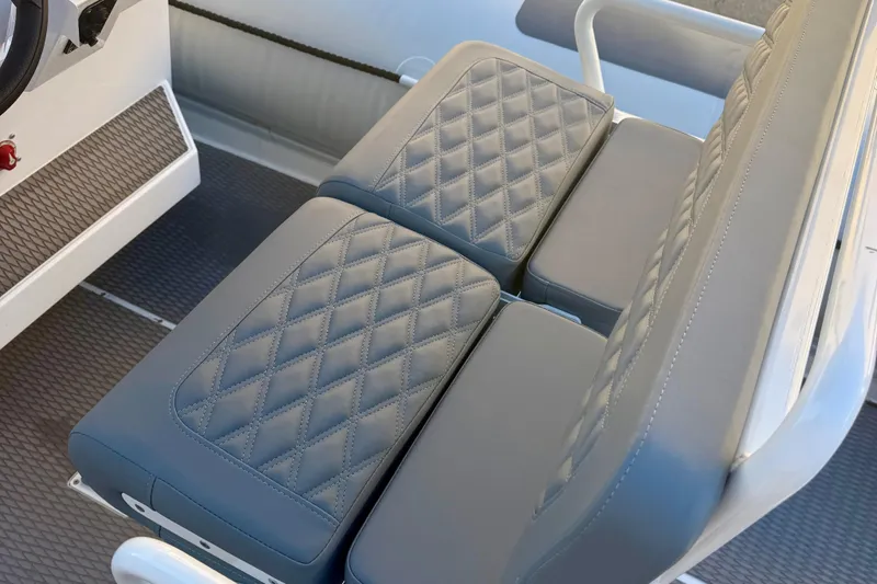 Slide: The Image of Control panel of 2025 Highfield Patrol 760 with cup holder and audio controls. - 16