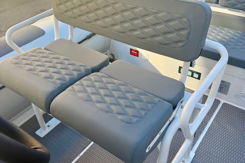 Slide: The Image of Control panel of 2025 Highfield Patrol 760 boat with cup holder and buttons. - 17