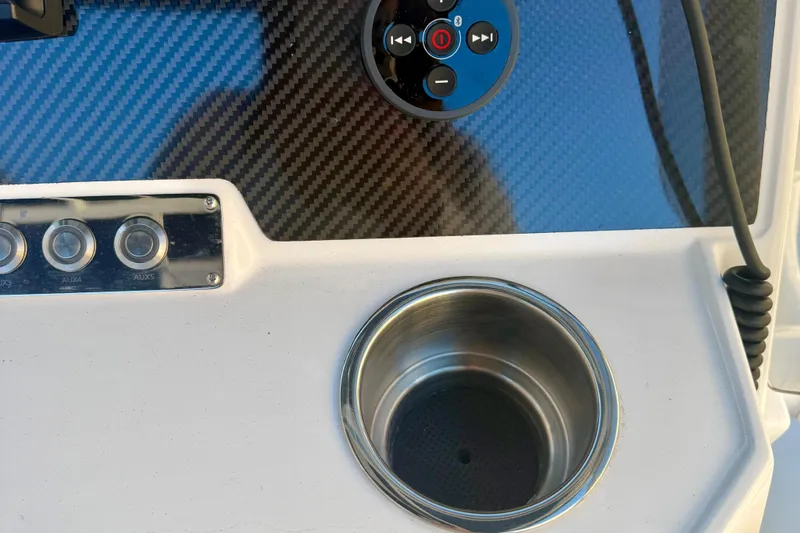 Slide: The Image of Control panel of 2025 Highfield Patrol 760 boat with steering wheel and throttle. - 19