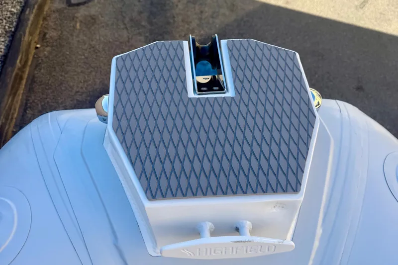 Slide: The Image of 2025 Highfield Patrol 760 boat with gray quilted seating and branding. - 28