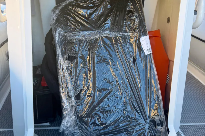 Slide: The Image of Interior view of 2025 Highfield Patrol 760 boat, featuring cushioned seating and textured flooring. - 29