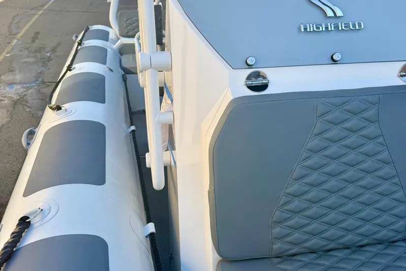 Slide: The Image of 2025 Highfield Patrol 760 boat on trailer, side view, outdoors. - 31