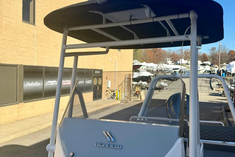 Slide: The Image of 2025 Highfield Patrol 760 boat, front view, docked between buildings. - 33