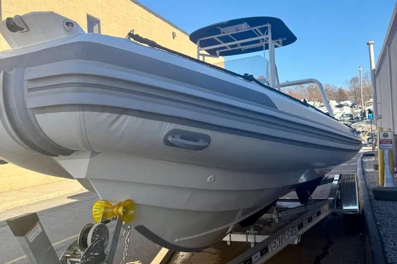 Slide: The Image of 2026 Highfield Patrol 760 boat with Yamaha V6 engine displayed indoors. - 34