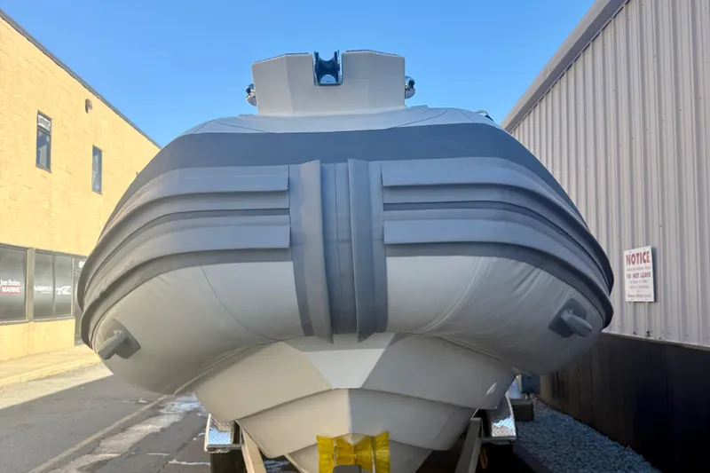 Slide: The Image of 2026 Highfield Patrol 760 boat in showroom, featuring sleek design and Yamaha engine. - 35