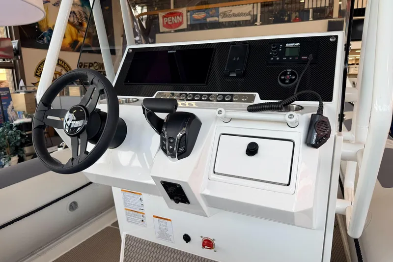 Slide: The Image of 2026 Highfield Patrol 760 boat dashboard with steering wheel and control panel. - 36