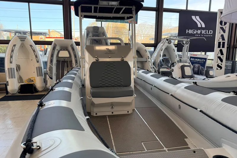Slide: The Image of 2026 Highfield Patrol 760 boat displayed in a showroom with other inflatable boats. - 37