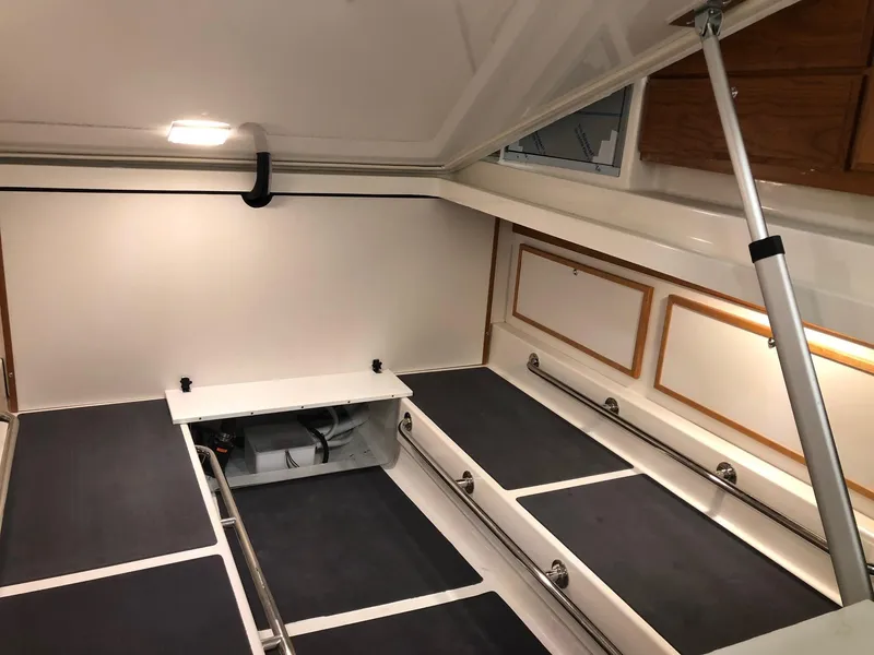 Slide: The Image of 2026 Back Cove 340 interior cabin with seating and storage compartments. - 22