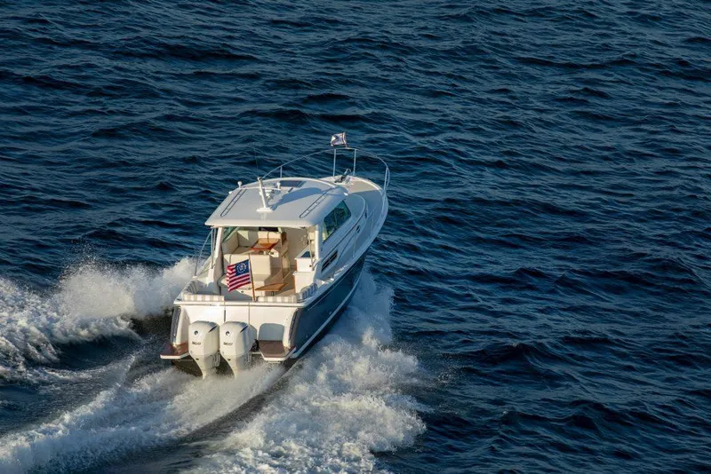 Slide: The Image of 2026 Back Cove 340 boat cruising on open water, rear view. - 1