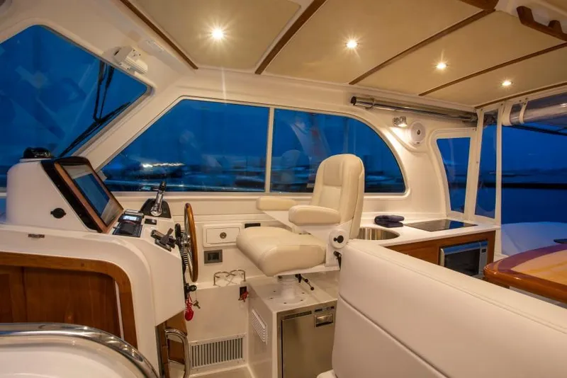 Slide: The Image of Interior of 2026 Back Cove 340 yacht with luxurious seating and modern controls. - 11