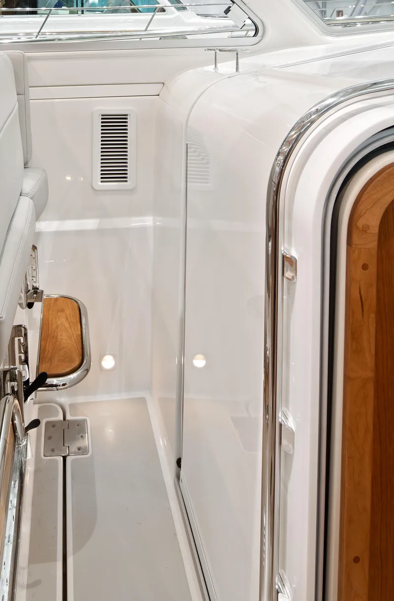 Slide: The Image of 2026 Back Cove 340 yacht interior with sleek white finish and wooden accents. - 15