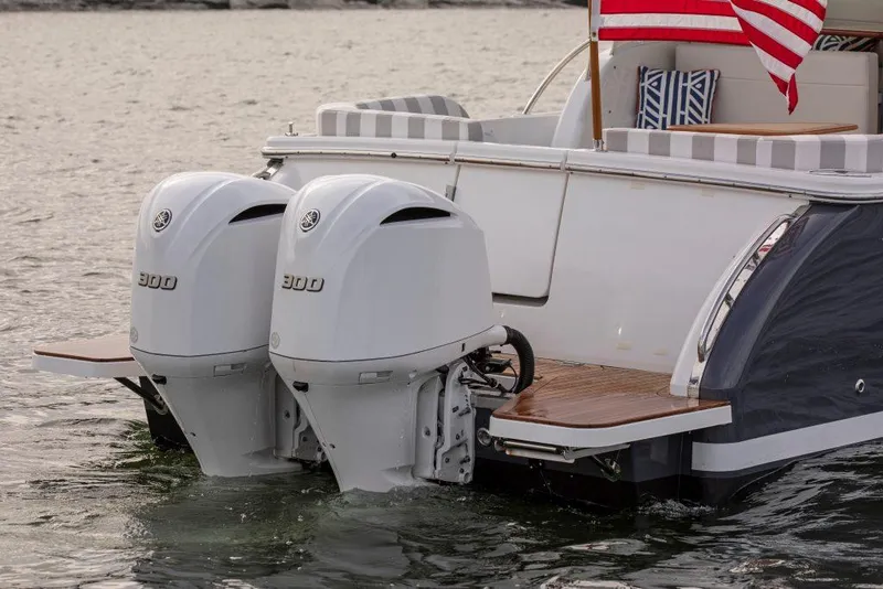 Slide: The Image of 2026 Back Cove 340 boat with twin 300 horsepower engines on water. - 3