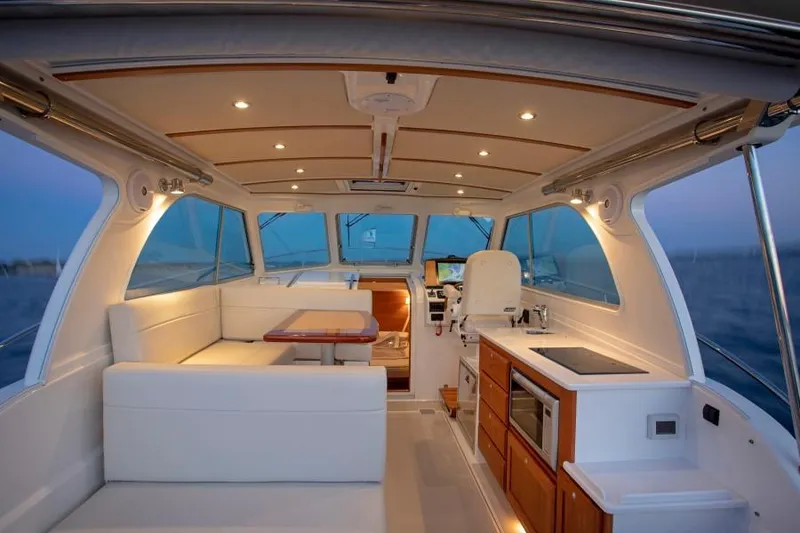 Slide: The Image of Interior of 2026 Back Cove 340 yacht with modern seating and kitchen area. - 6