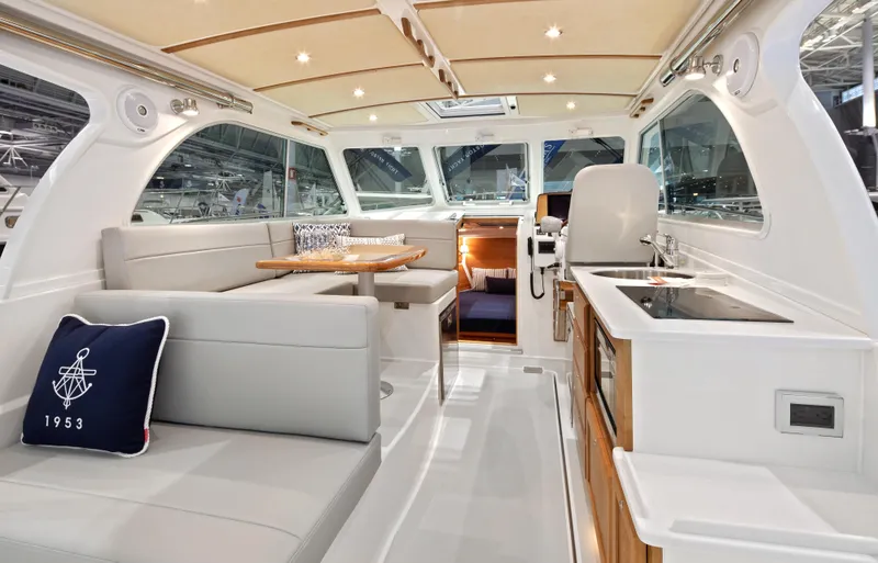 Slide: The Image of Interior of 2026 Back Cove 340 yacht, featuring modern seating and kitchen area. - 8