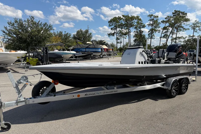 The Image of 2026 Blazer 675 Ultimate Bay boat on trailer, parked outdoors under a clear sky. - 1