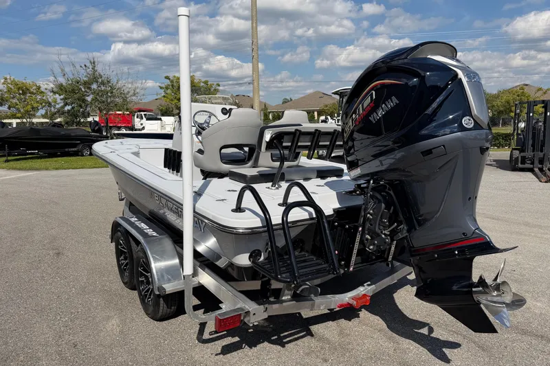 Slide: The Image of 2026 Blazer 675 Ultimate Bay boat with Yamaha engine, parked outdoors. - 15