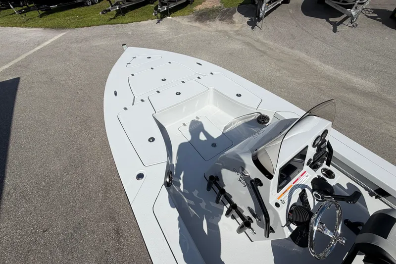 Slide: The Image of 2026 Blazer 675 Ultimate Bay boat, sleek design, spacious deck, modern controls, parked outdoors. - 7