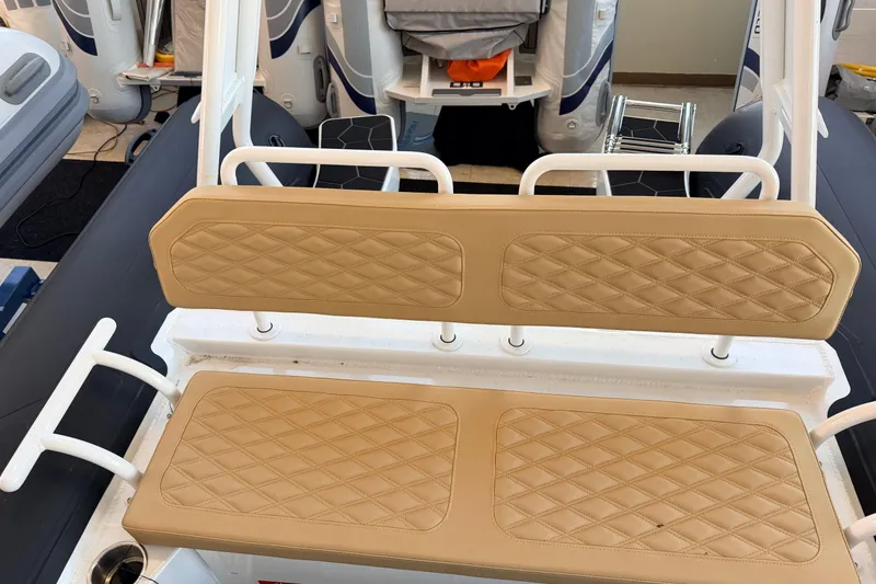 Slide: The Image of 2026 Highfield Sport 660 boat with tan quilted seating and white frame. - 15