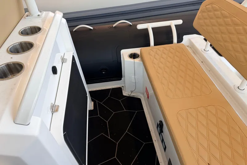 Slide: The Image of Interior of 2026 Highfield Sport 660 boat with tan quilted seating and cup holders. - 16