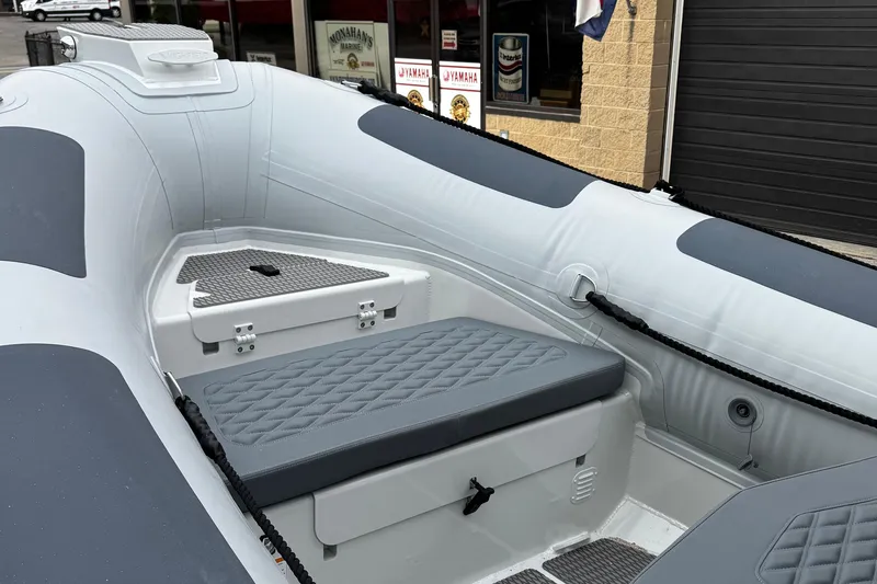 Slide: The Image of 2026 Highfield Patrol 600 boat interior with cushioned seating and storage. - 10