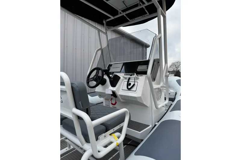 Slide: The Image of 2026 Highfield Patrol 600 boat interior with gray seating and storage compartments. - 11