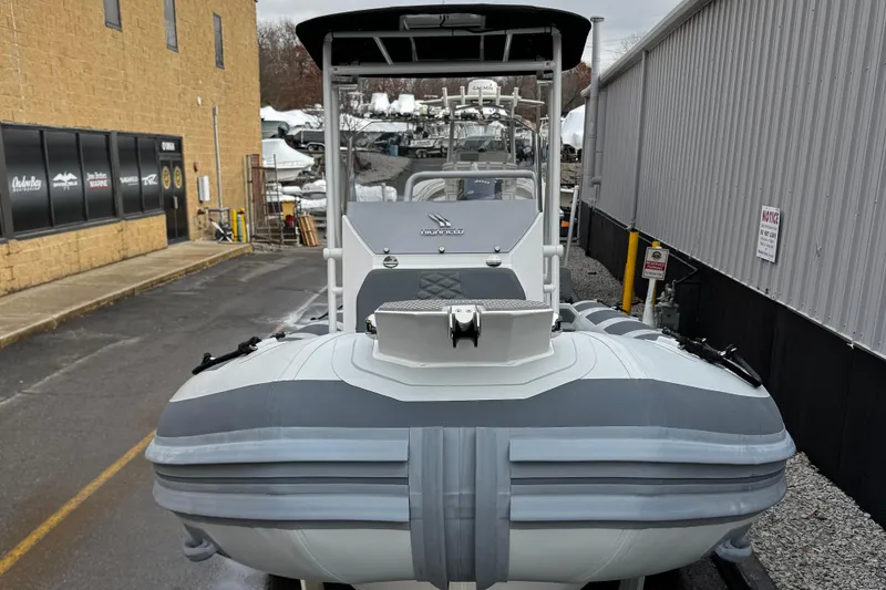 Slide: The Image of 2026 Highfield Patrol 600 boat on trailer, parked near a building. - 5