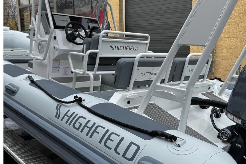 Slide: The Image of 2026 Highfield Patrol 600 with Yamaha 150 outboard engine, close-up view. - 8