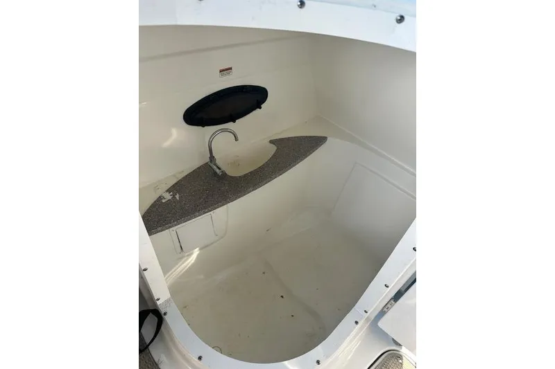 Slide: The Image of 2019 Hurricane SunDeck 2410 OB boat interior with sink and countertop. - 12