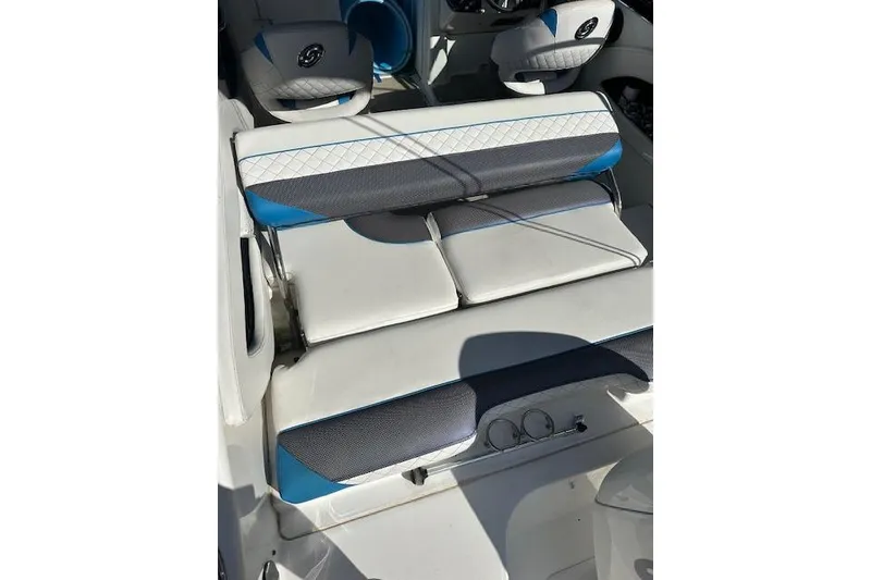 Slide: The Image of 2019 Hurricane SunDeck 2410 OB boat interior with blue and white seating. - 13
