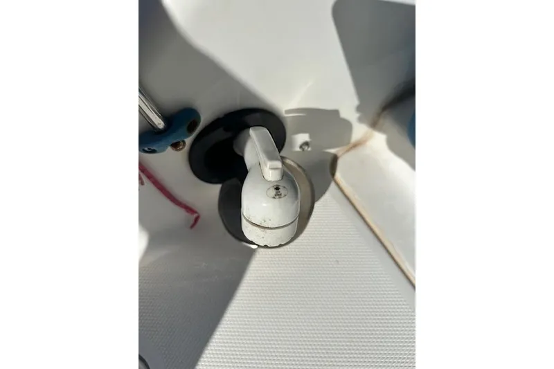Slide: The Image of Boat deck detail of 2019 Hurricane SunDeck 2410 OB, featuring a white lever. - 14