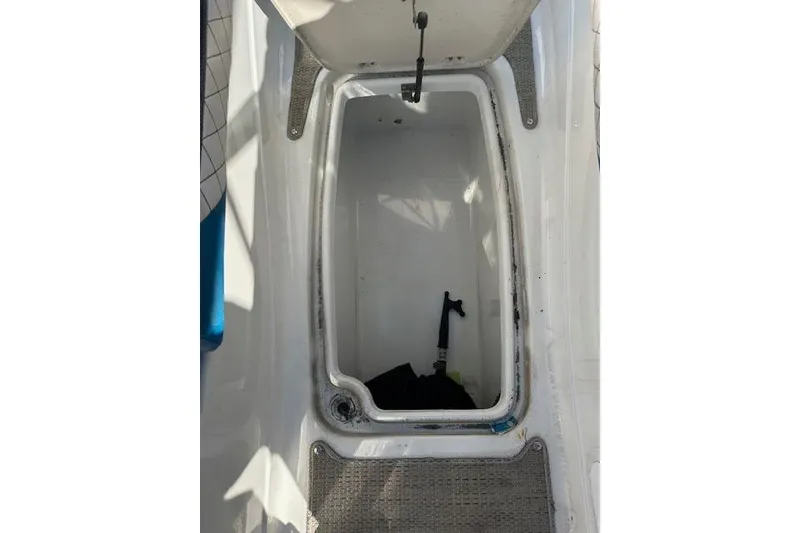 Slide: The Image of Open storage compartment on 2019 Hurricane SunDeck 2410 OB boat. - 21