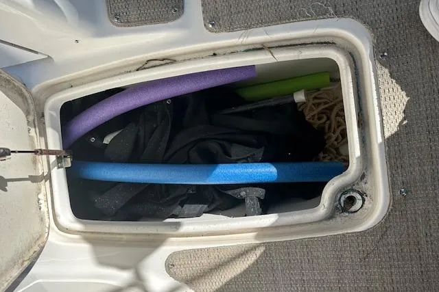 Slide: The Image of Storage compartment on 2019 Hurricane SunDeck 2410 OB with pool noodles and rope. - 22