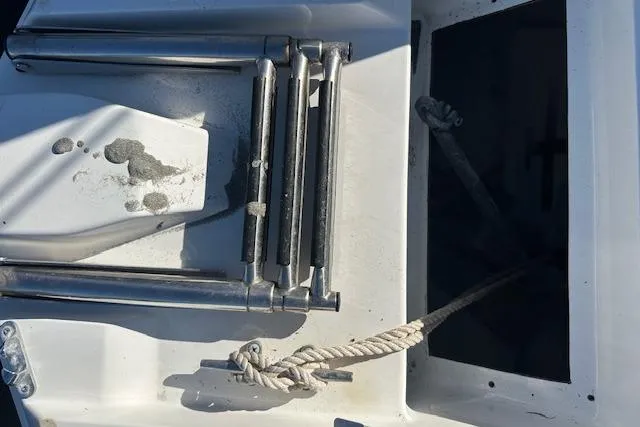 Slide: The Image of 2019 Hurricane SunDeck 2410 OB boat ladder and rope detail. - 25