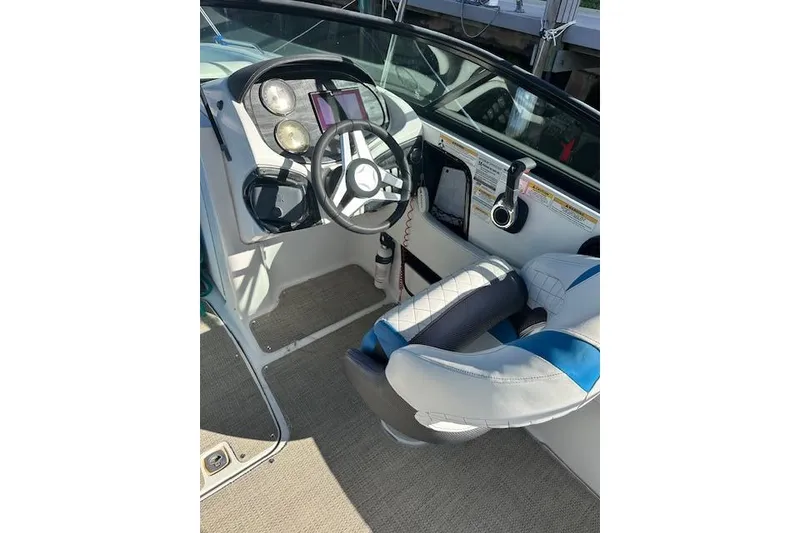 Slide: The Image of 2019 Hurricane SunDeck 2410 OB boat interior with steering wheel and dashboard controls. - 5