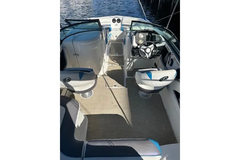 Slide: The Image of 2019 Hurricane SunDeck 2410 OB boat interior with seating and steering wheel. - 6