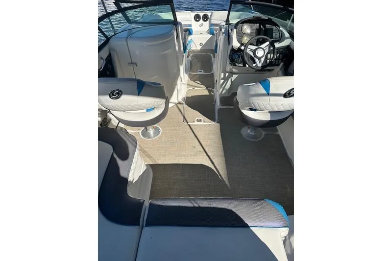 Slide: The Image of 2019 Hurricane SunDeck 2410 OB boat interior with seating and steering console. - 9