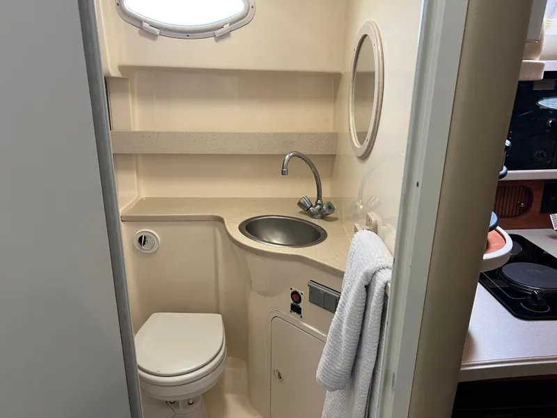 Slide: The Image of 2003 Rinker Fiesta Vee 342 bathroom with sink, toilet, and towel. - 12
